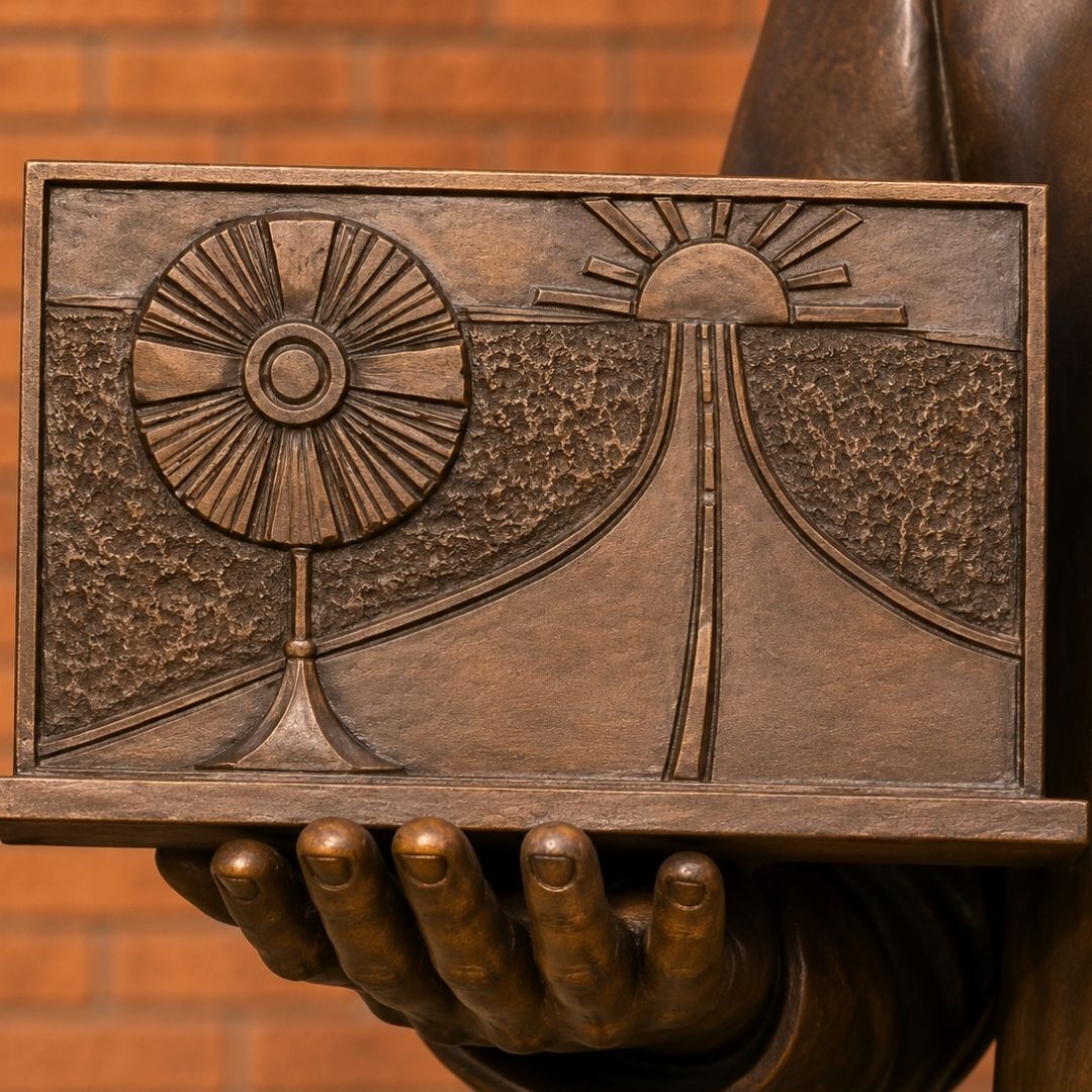 St. Carlo Acutis sculpture laptop showing a monstrance highway and setting sun