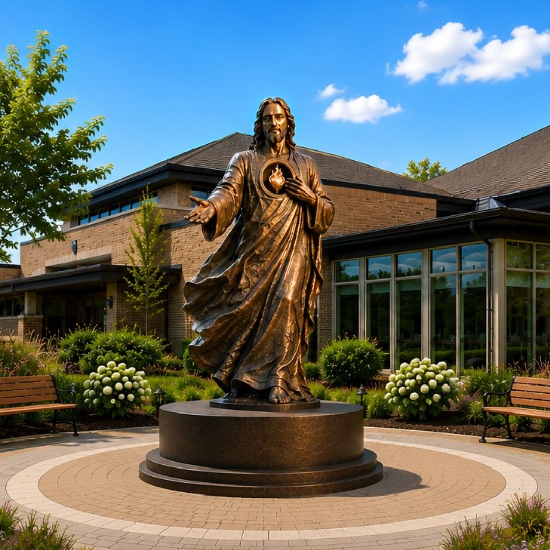 Sacred Heart of Jesus sculpture by Indweller Artistic integrated into church campus design with landscaping, benches, and gathering space.
