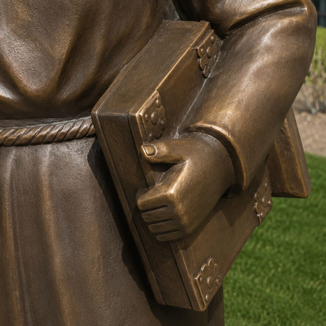 Close-up of the manuscript held by the St. Clare of Assisi sculpture representing her Rule of Life.