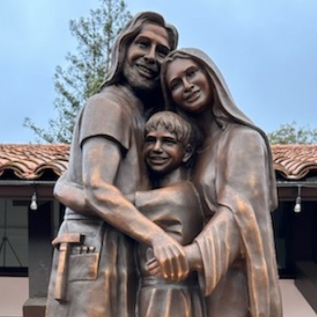 Detail showing the heart formed by Joseph and Mary's joined hands in the Heart of a Happy Family sculpture